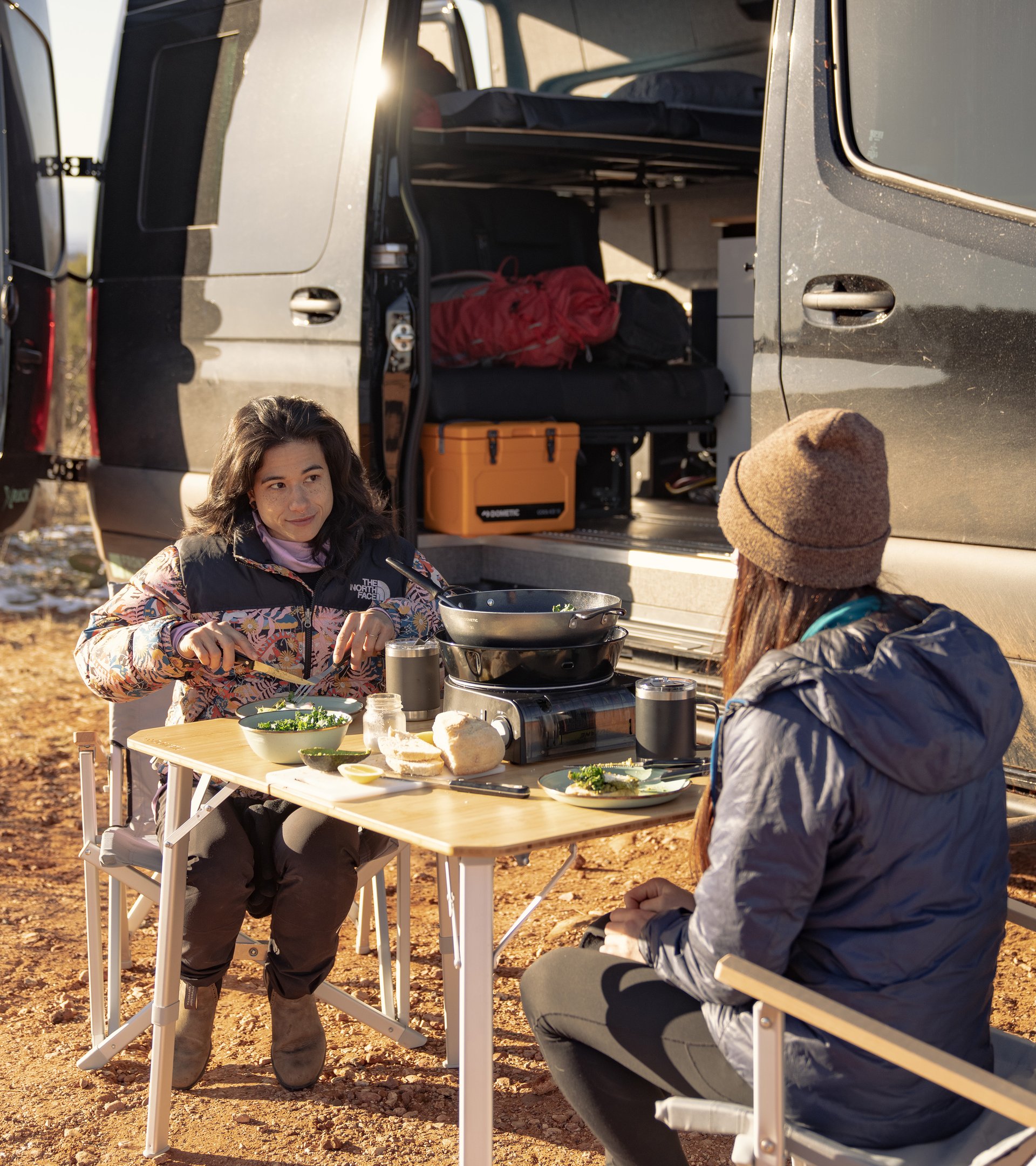 Two women eating outdoors using Dometic product