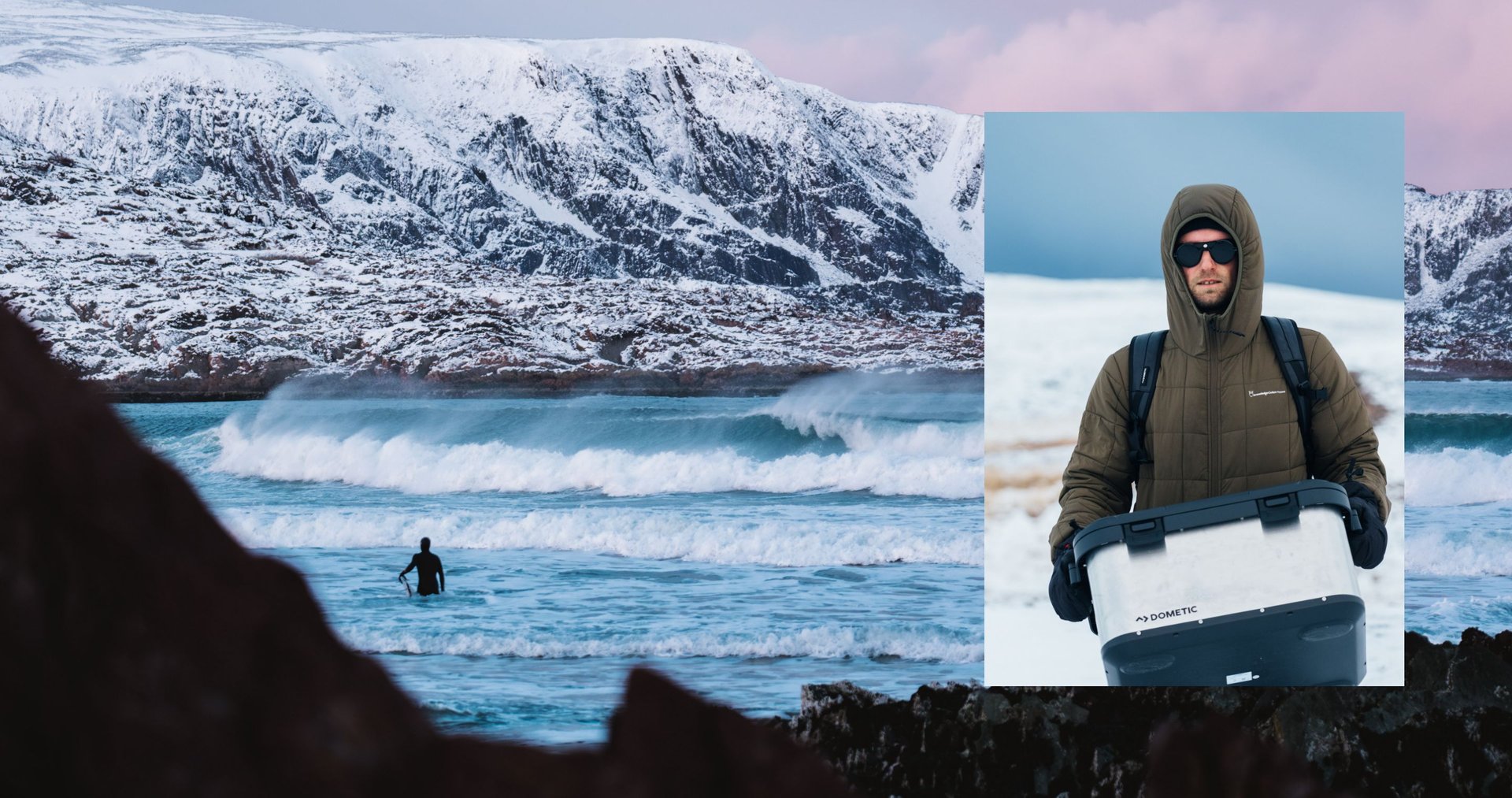 A male wearing winter outdoor clothing in the snow holding a Dometic Hard Storage