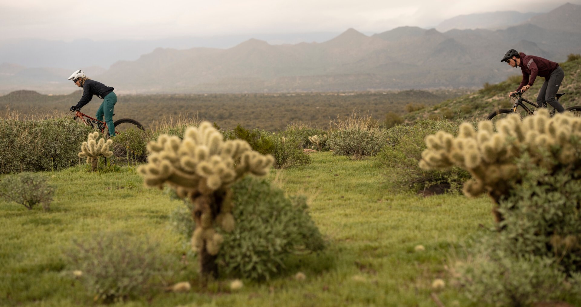 2 people mountain biking in nature
