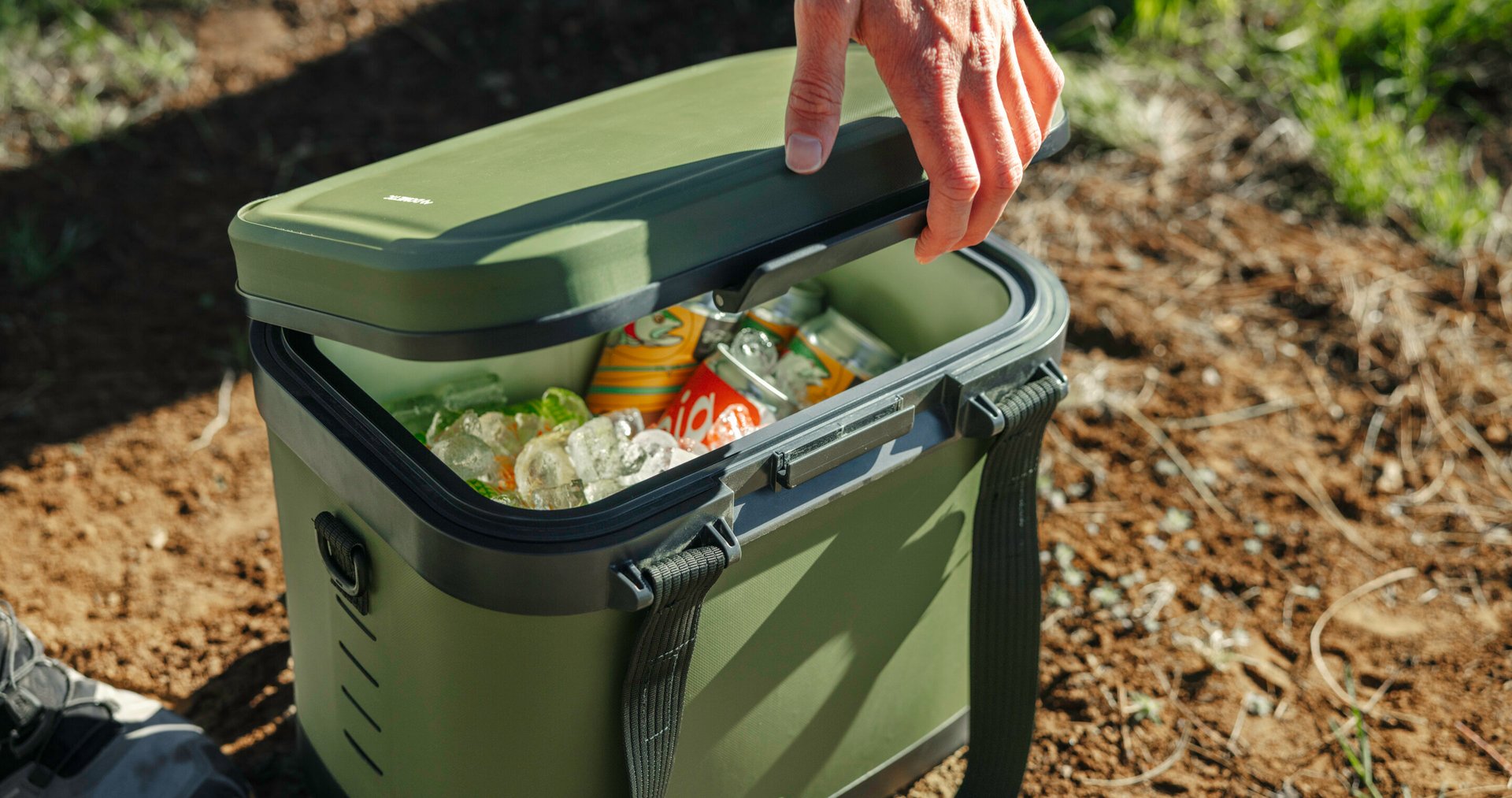 Opening soft cooler full of canned drinks.