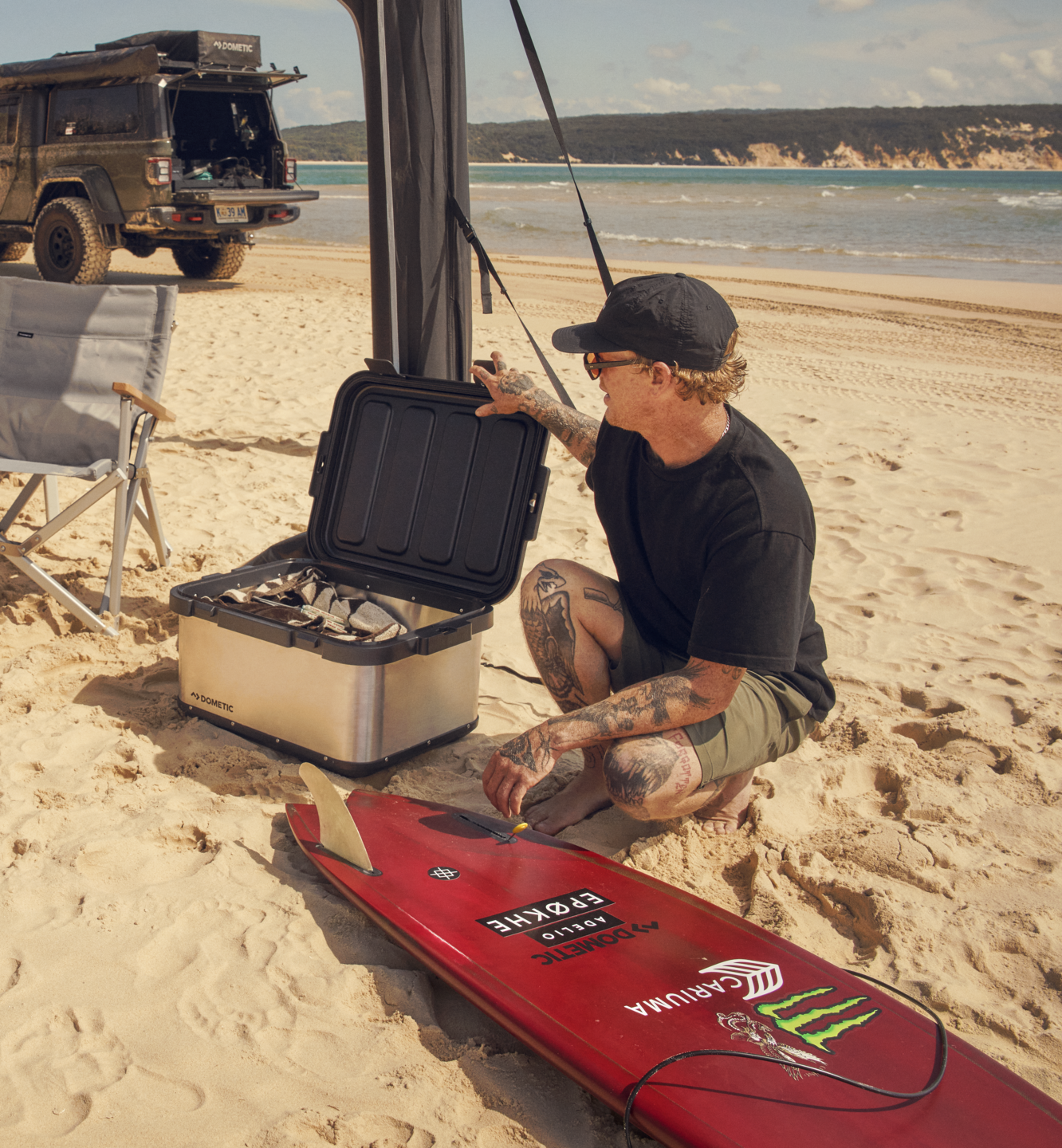 Surfer on beach with Dometic storage