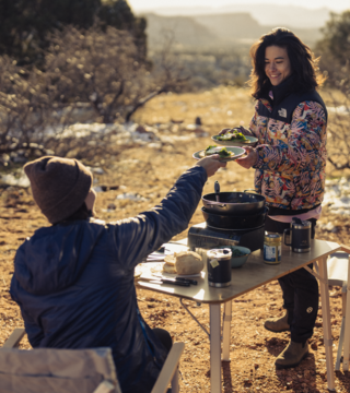 Women serving food while camping