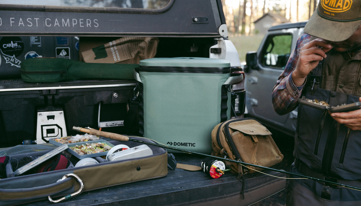 Soft cooler among fishing equipment on flatbed truck