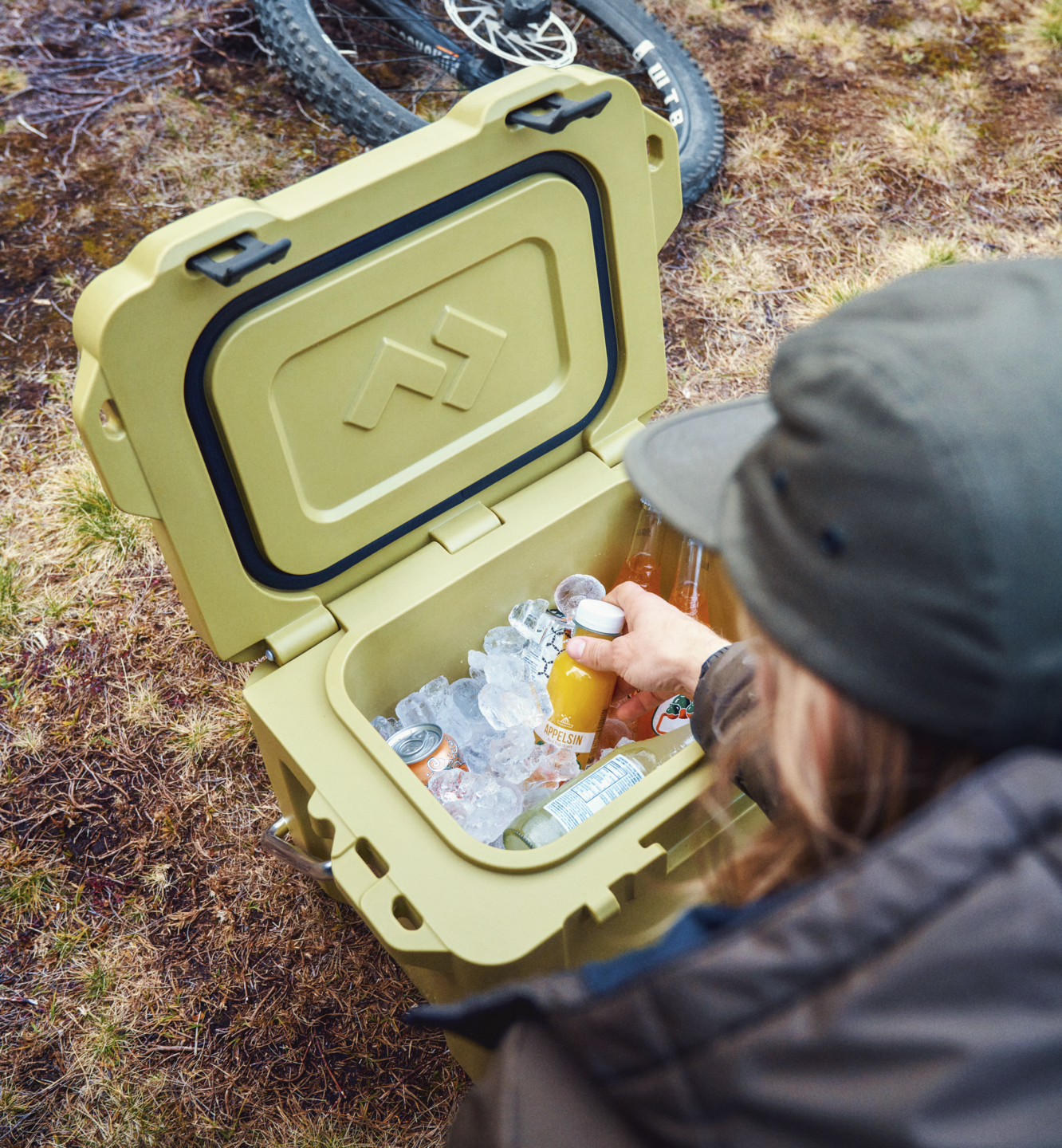 Mountain Biker reaching into Dometic patrol ice chest cooler
