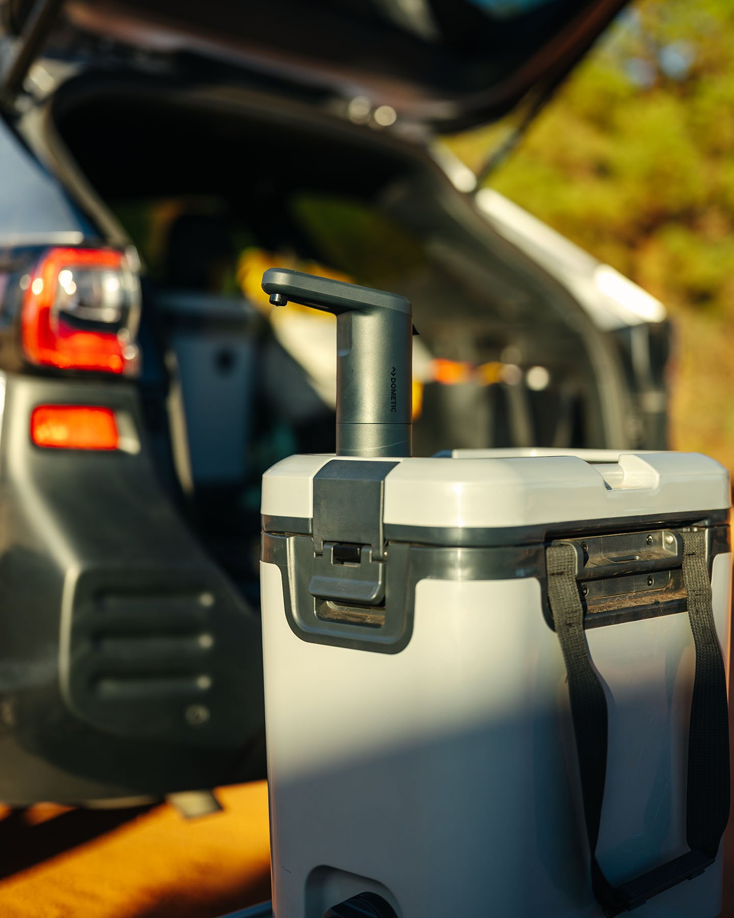 jug with faucet in front of a vehicle