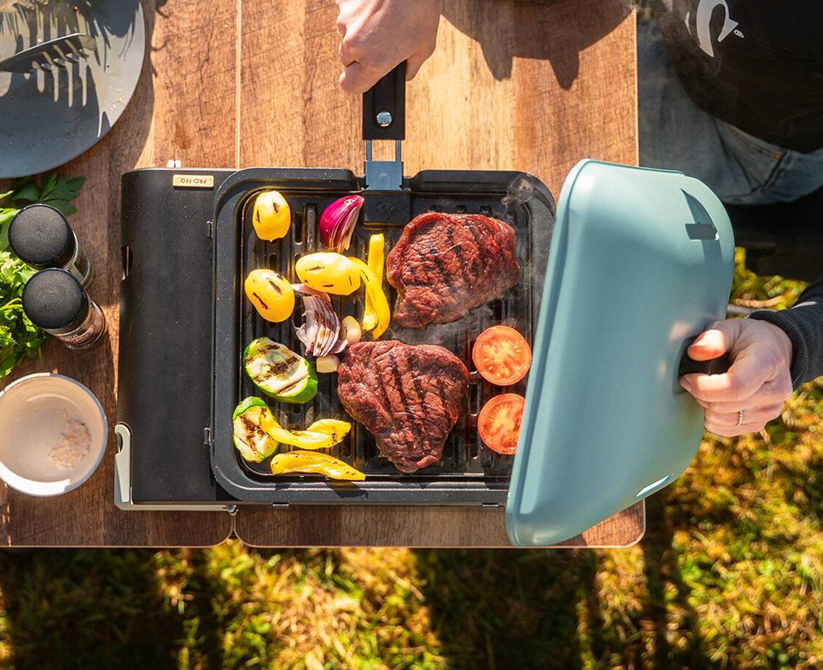 CADAC Van Cook FFD portable gas grill cooking steaks and grilled vegetables outdoors, compact barbecue with grill plate for camping and outdoor cooking