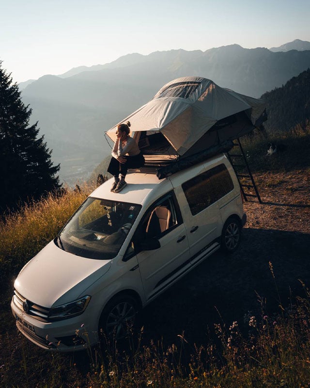 Feather-Lite II rooftop tent mounted on a camper van in a mountain landscape, lightweight rooftop camping solution for outdoor adventures
