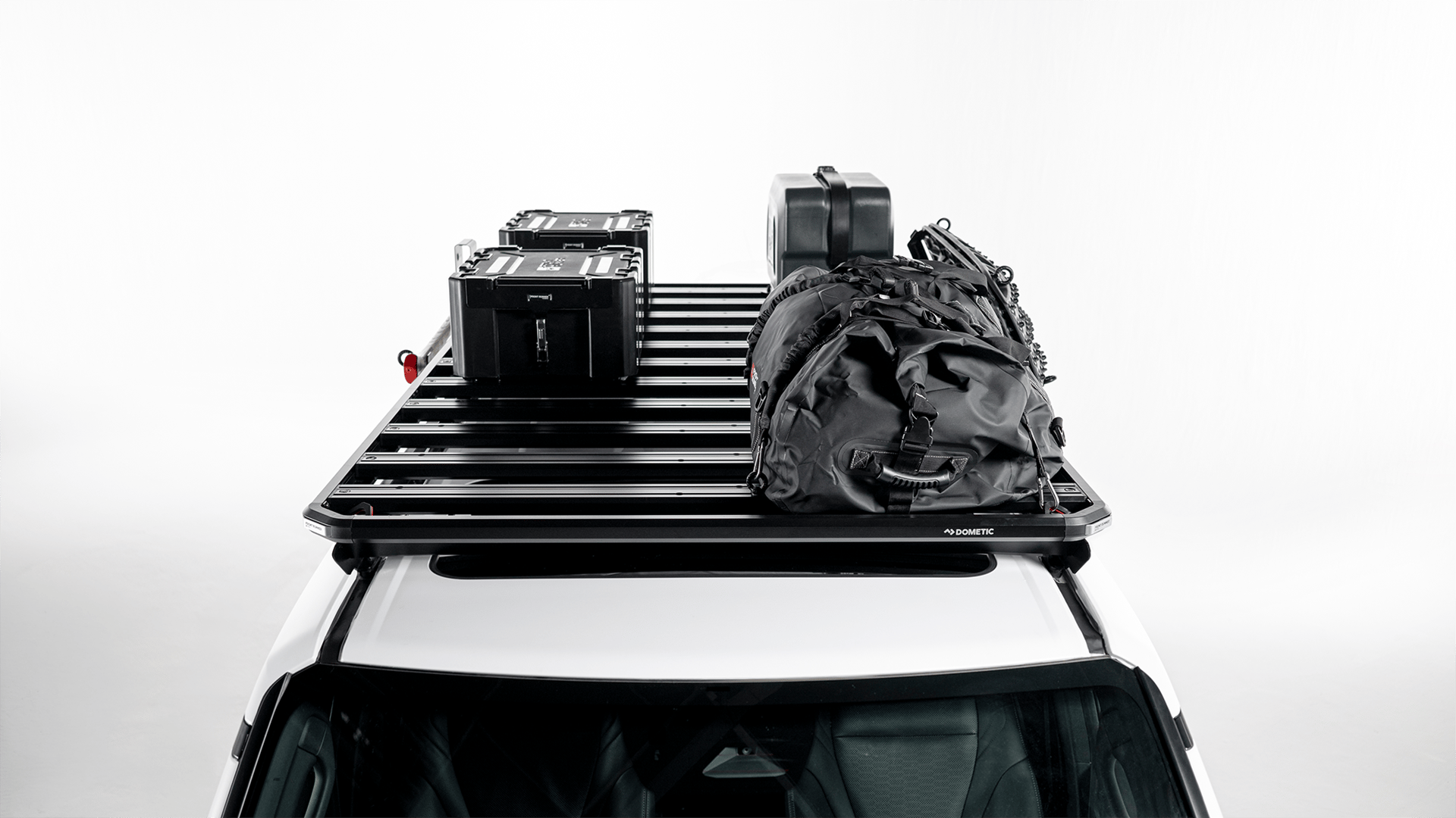 Dometic Front Runner Series Slimline 3 roof rack loaded with storage boxes, jerry can and gear bag, modular cargo platform for overland travel