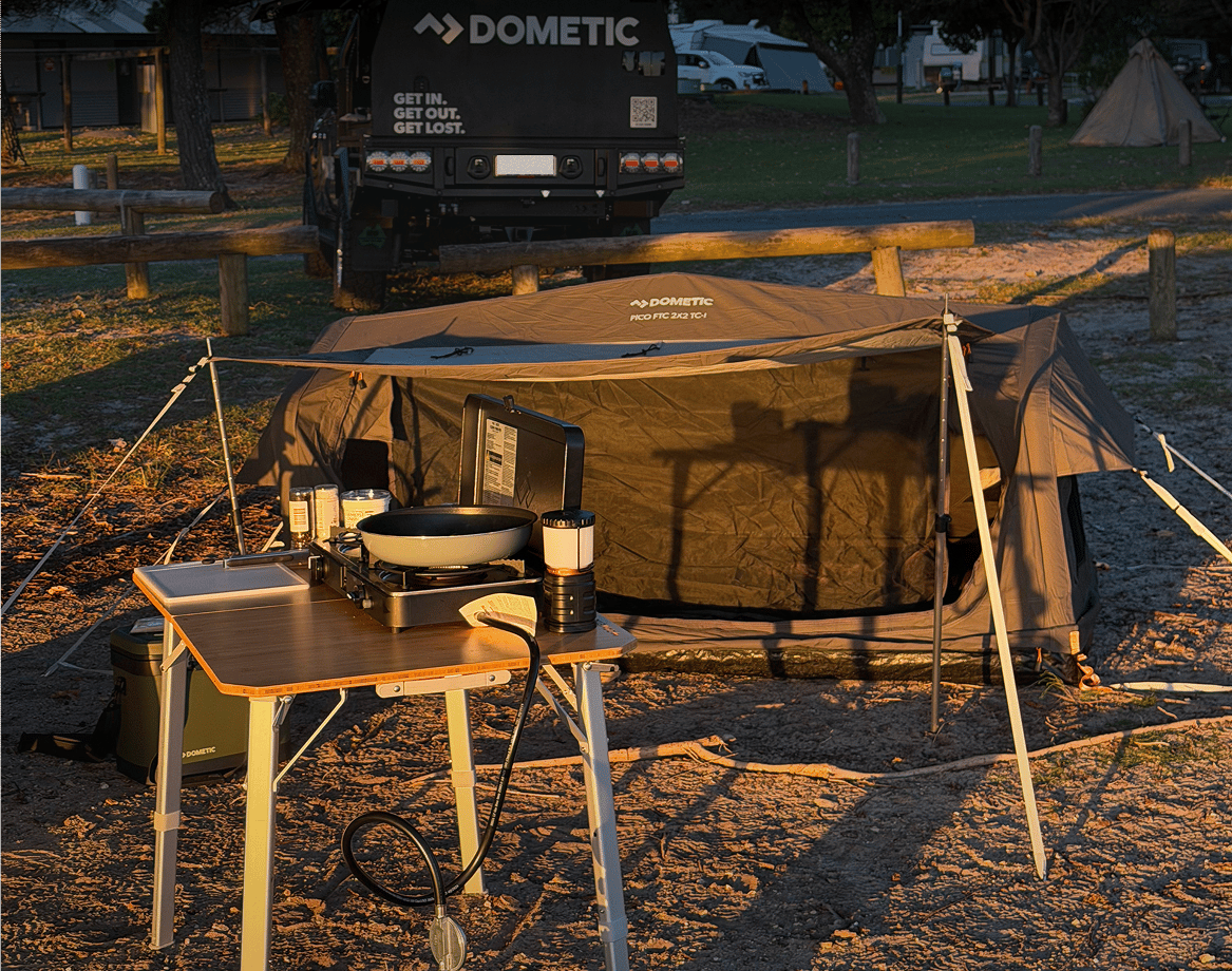 Harry Holland's Dometic camp set up is complete, featuring a Pico Swag, Camp table and cooker. With the golden glow of sunset reflecting he's in for a nice night under the stars..
