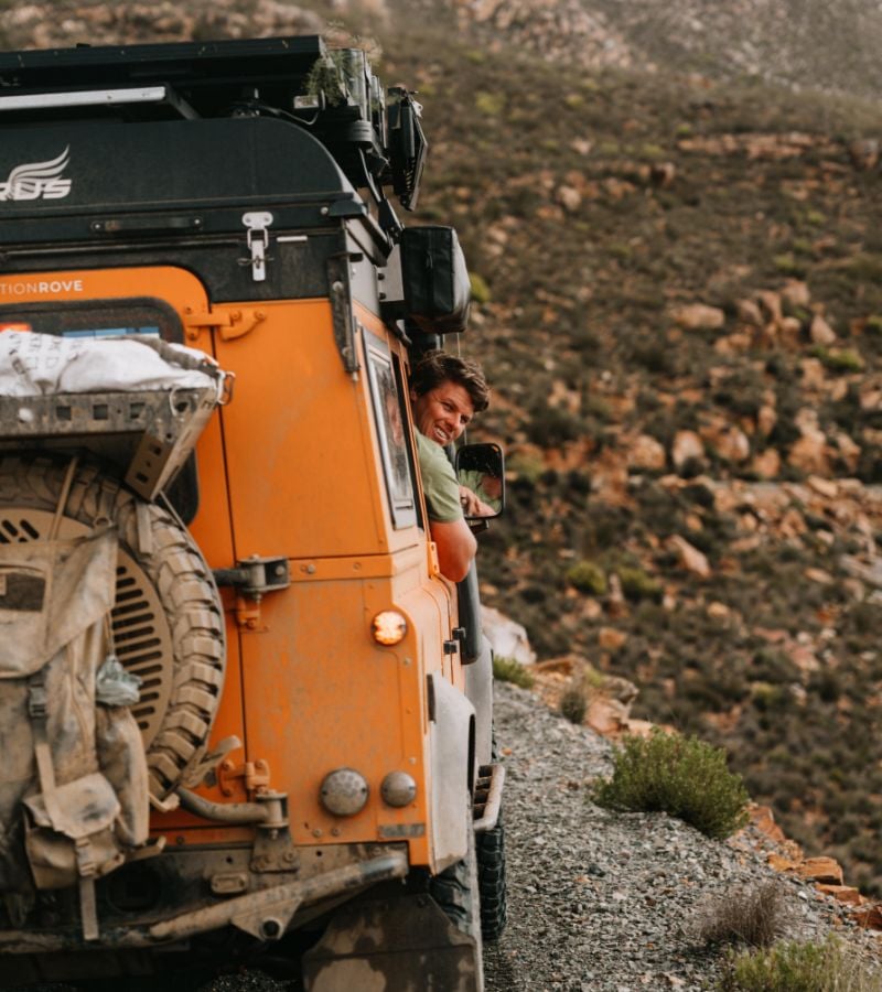 Back of vehicle with driver looking out window