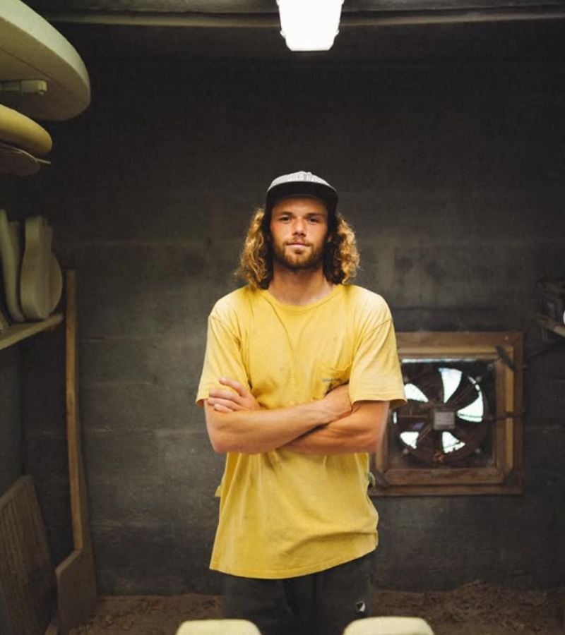 Man with arms crossed in a yellow Tshirt