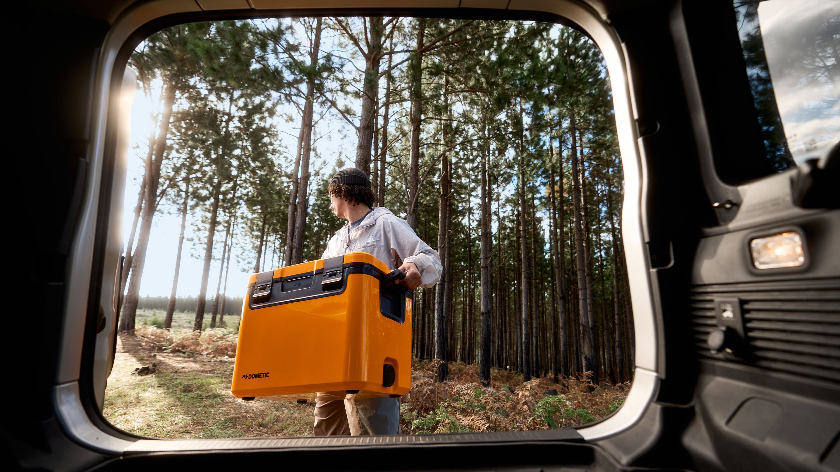 man walking behink trunk with glow recon cooler