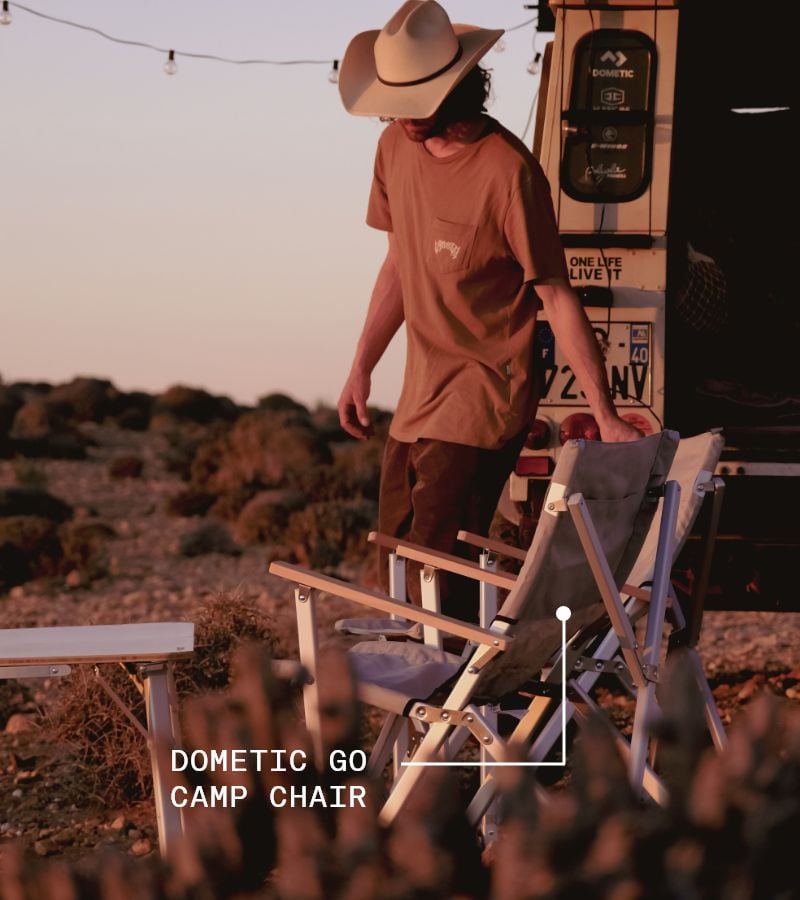 Man pulling out camp chair