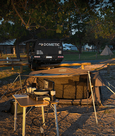 Harry Holland's Dometic camp set up is complete, featuring a Pico Swag, Camp table and cooker. With the golden glow of sunset reflecting he's in for a nice night under the stars..