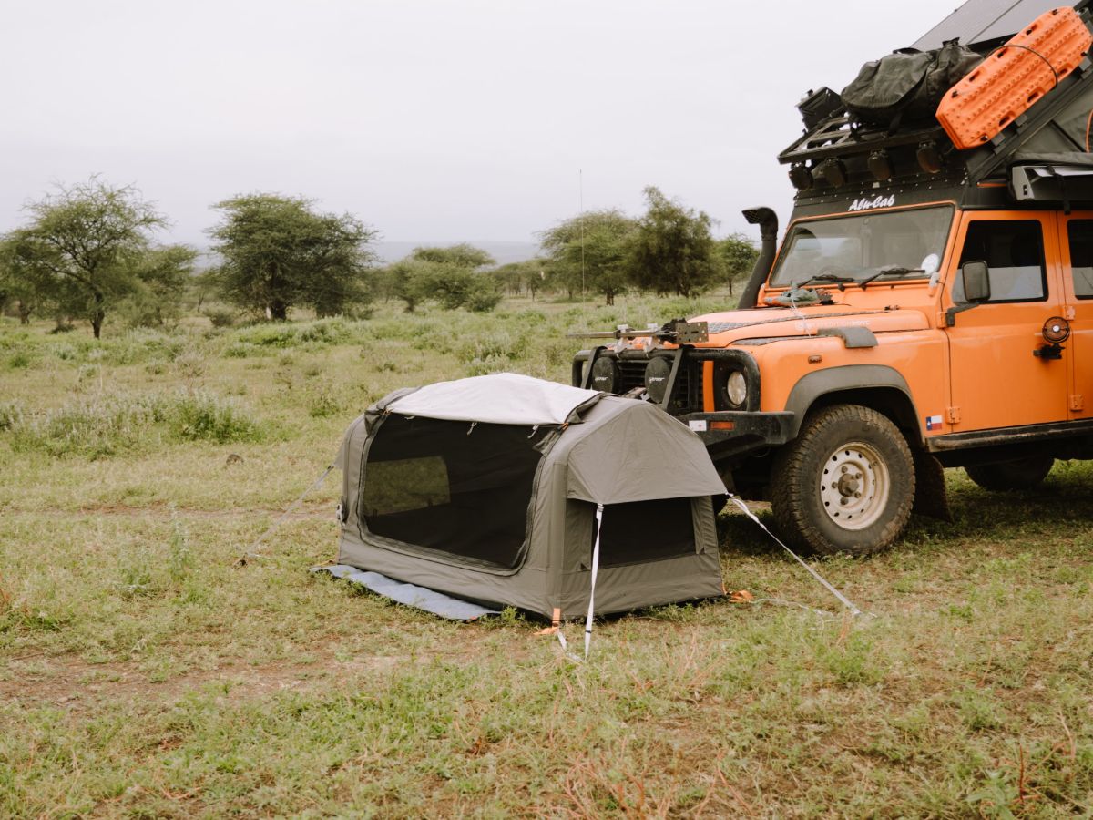 Inflatable swag on green grass with vehicle