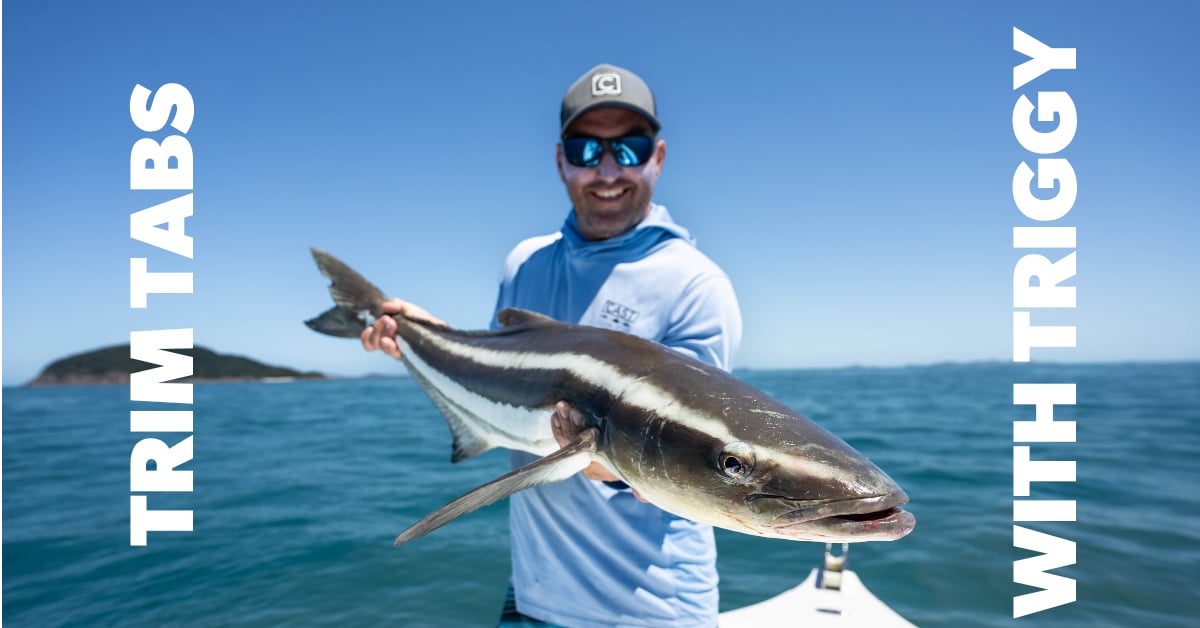 Man on boat with large fish with white text overlay