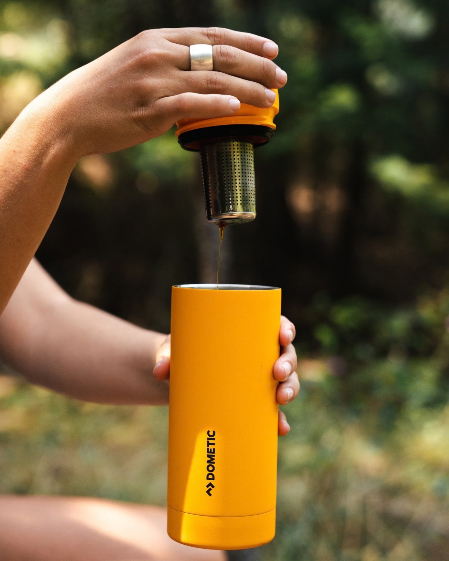 Tea Infuser inserting into glow colored tumbler. 