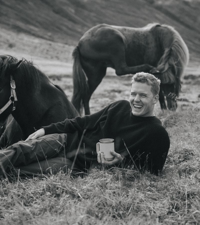 Kitae Wilson laying in grass with Dometic cup