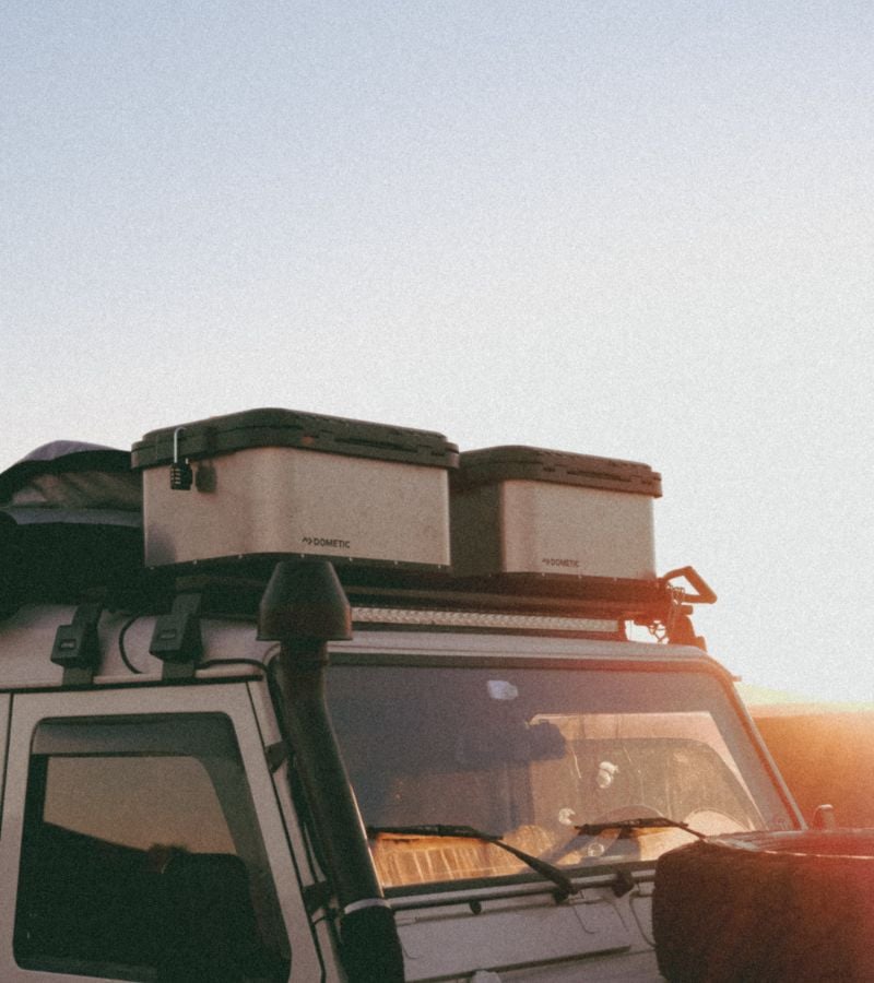 Image of car with storage boxes on roof racks