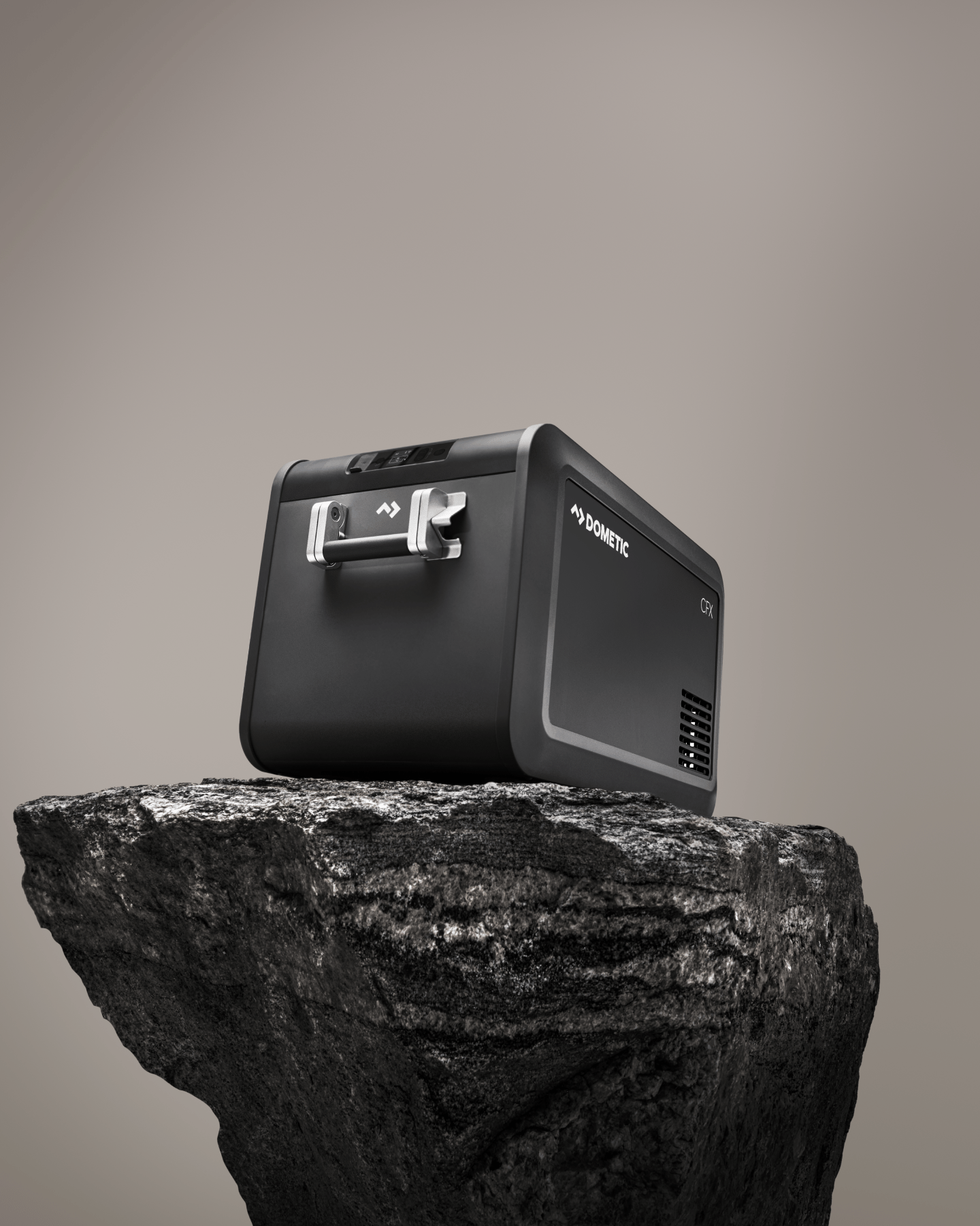 Black CFX electric cooler on top of rock