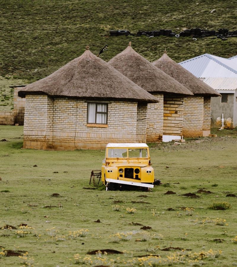 Car parked in front of huts