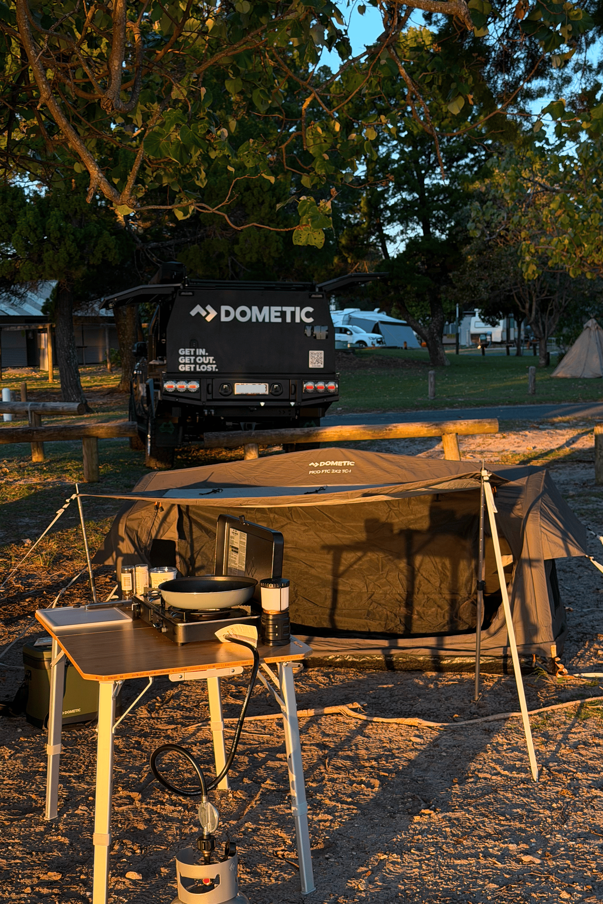Harry Holland's Dometic camp set up is complete, featuring a Pico Swag, Camp table and cooker. With the golden glow of sunset reflecting he's in for a nice night under the stars..