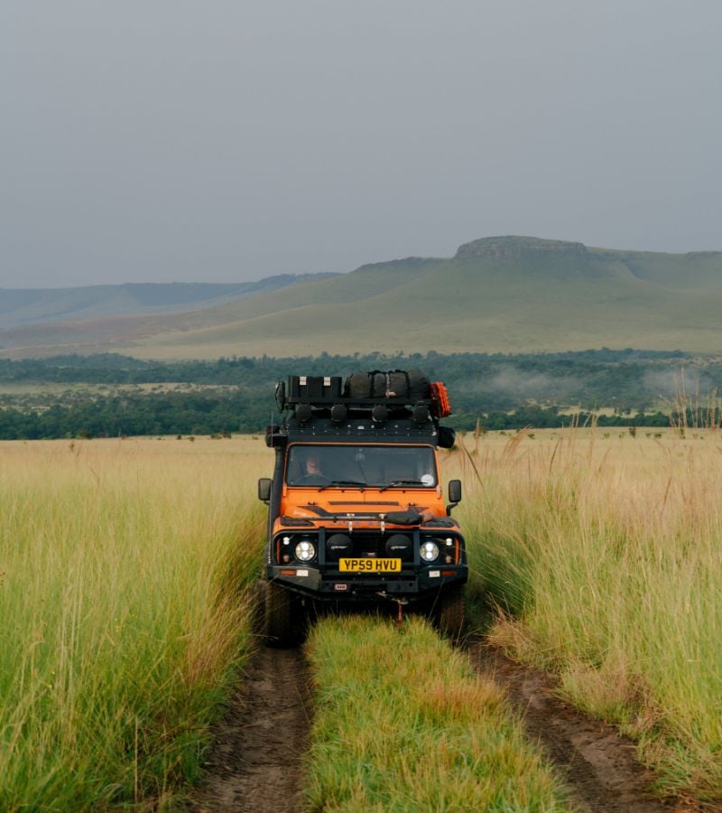Front of vehicle driving on grass track
