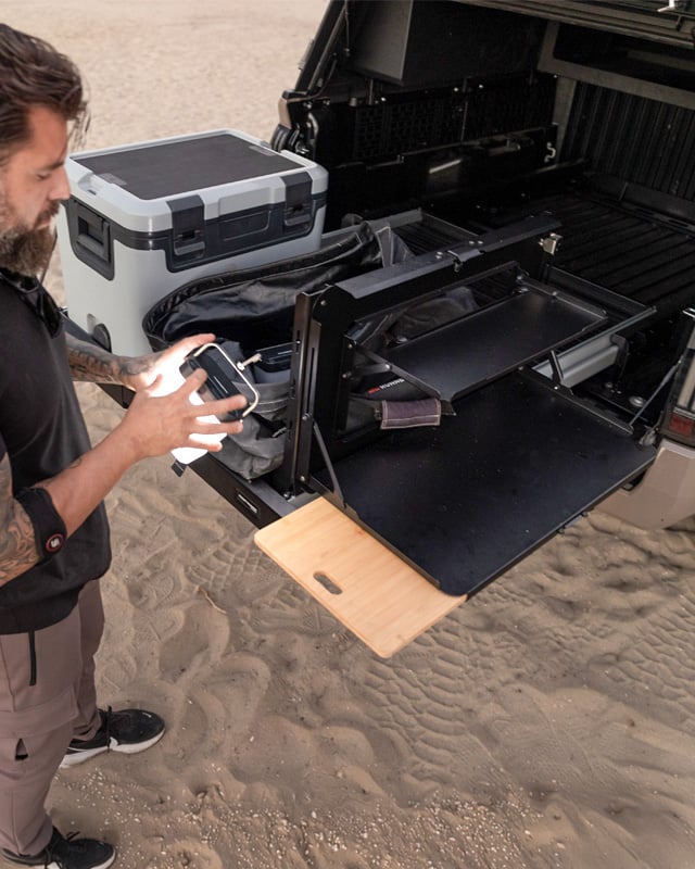 Cargo bed slide extended with cooler, light and gear.