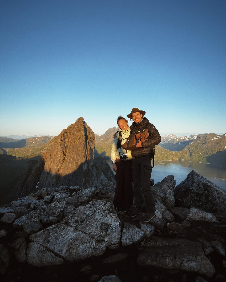 Outdoorsy couple standing on top of a mountain