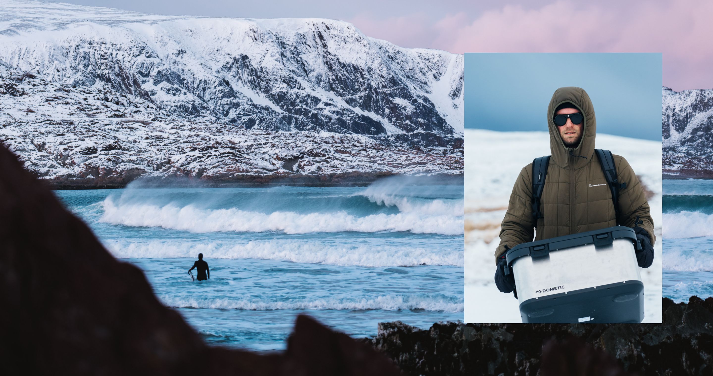 A male wearing winter outdoor clothing in the snow holding a Dometic Hard Storage