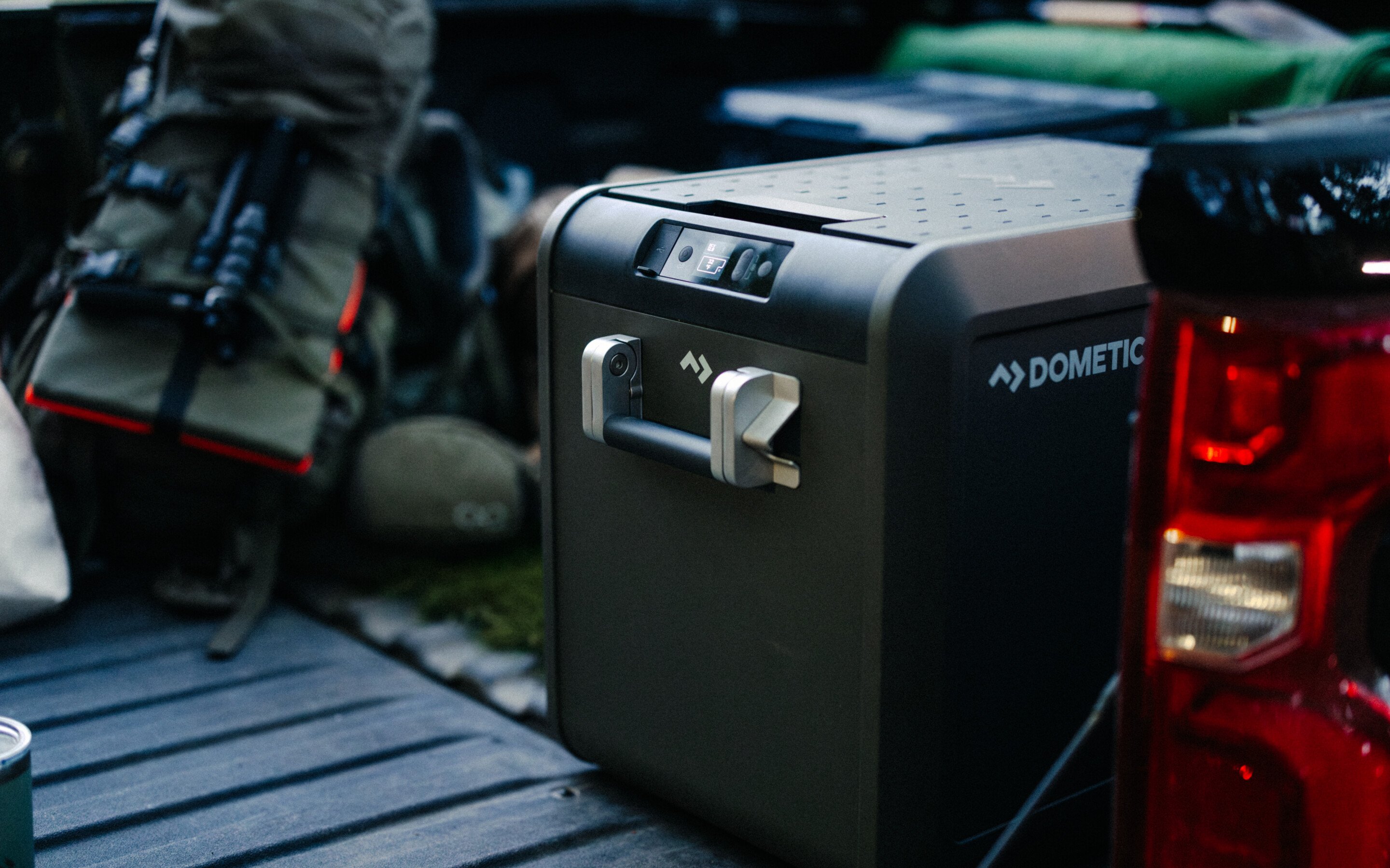 CFX5 cooler in bed of truck along with camping and outdoor gear.