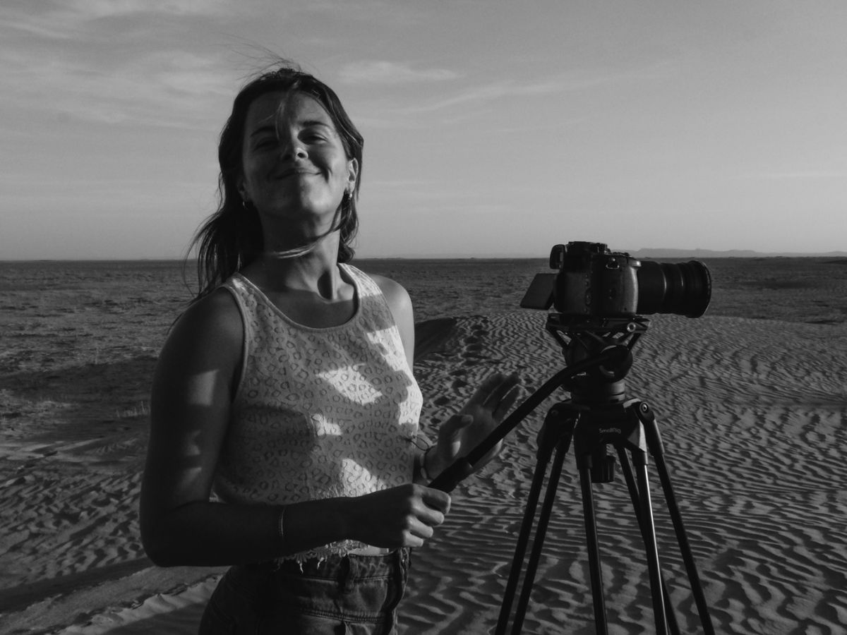 Black and white image of woman with camera