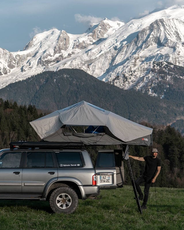 Feather-Lite II rooftop tent mounted on a camper van in a mountain landscape, lightweight rooftop camping solution for outdoor adventures