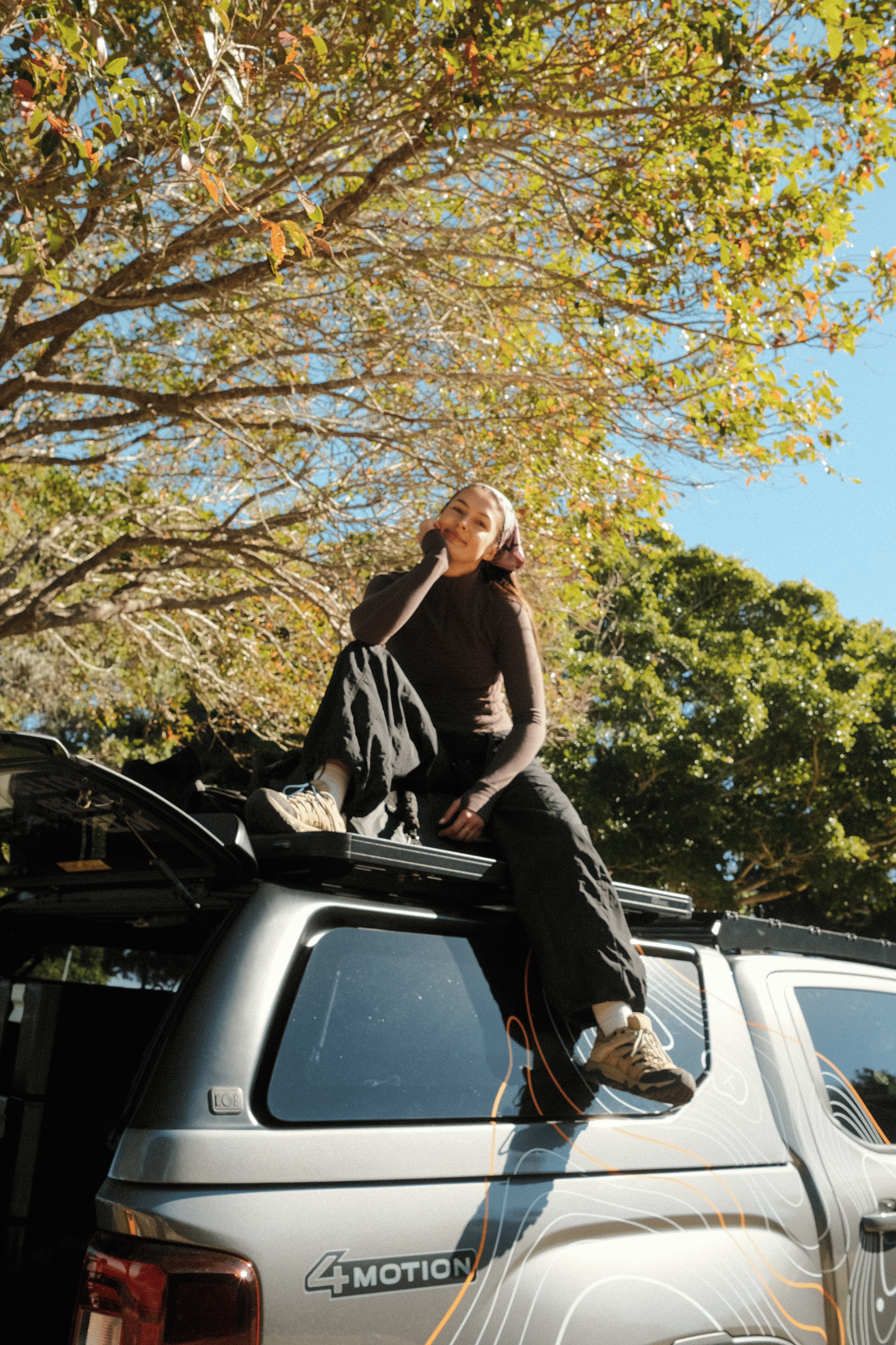 Breanna Hurst sitting on a Dometic 4WD during the Parked to Park camping giveaway, enjoying an outdoor adventure on North Stradbroke Island.