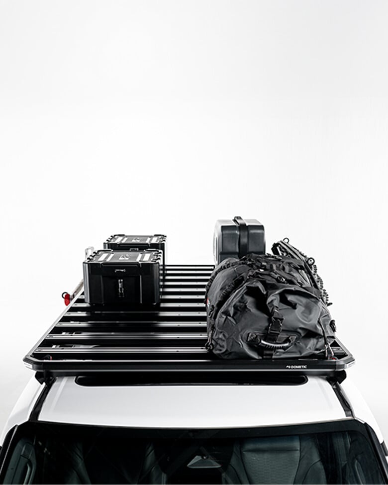 Slimline 3 roof rack loaded with storage boxes, jerry can and gear bag, modular roof rack platform shown mounted on a vehicle