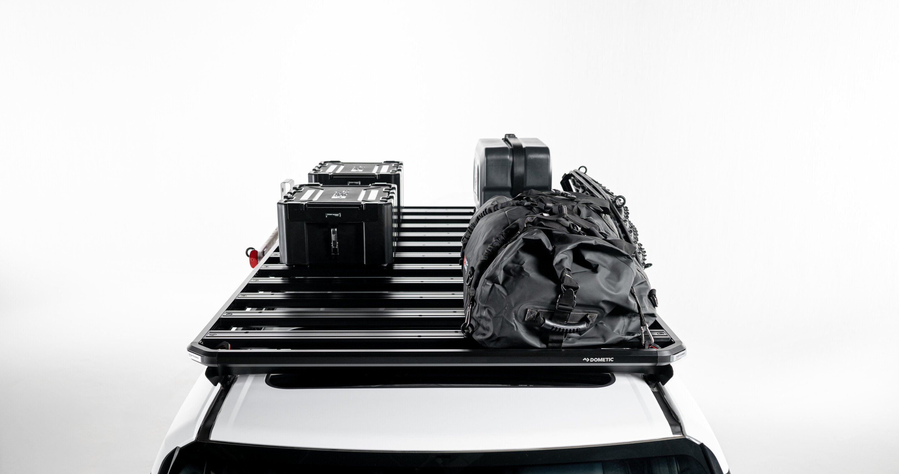 Slimline 3 roof rack loaded with storage boxes, jerry can and gear bag, modular roof rack platform shown mounted on a vehicle