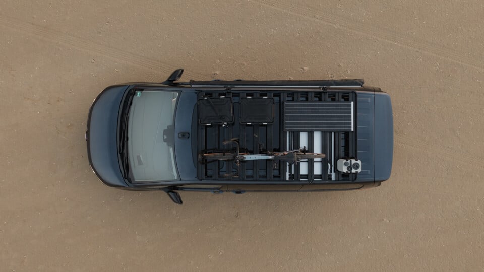 Roof rack viewed from above with recovery boards, utility accessories and mounted gear, showcasing accessory compatibility on a vehicle roof platform