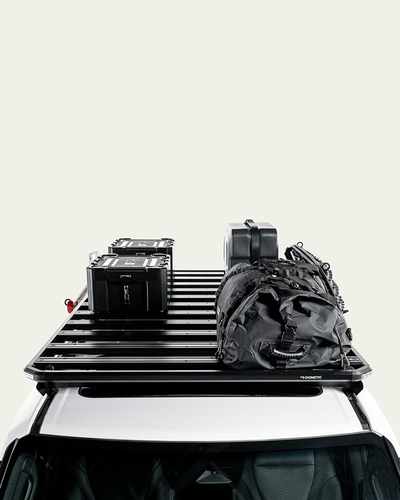 Slimline 3 roof rack loaded with storage boxes, jerry can and gear bag, modular roof rack platform shown mounted on a vehicle