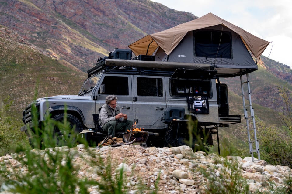 Overlanding Camp with a man sitting in a Front Runner camping chair