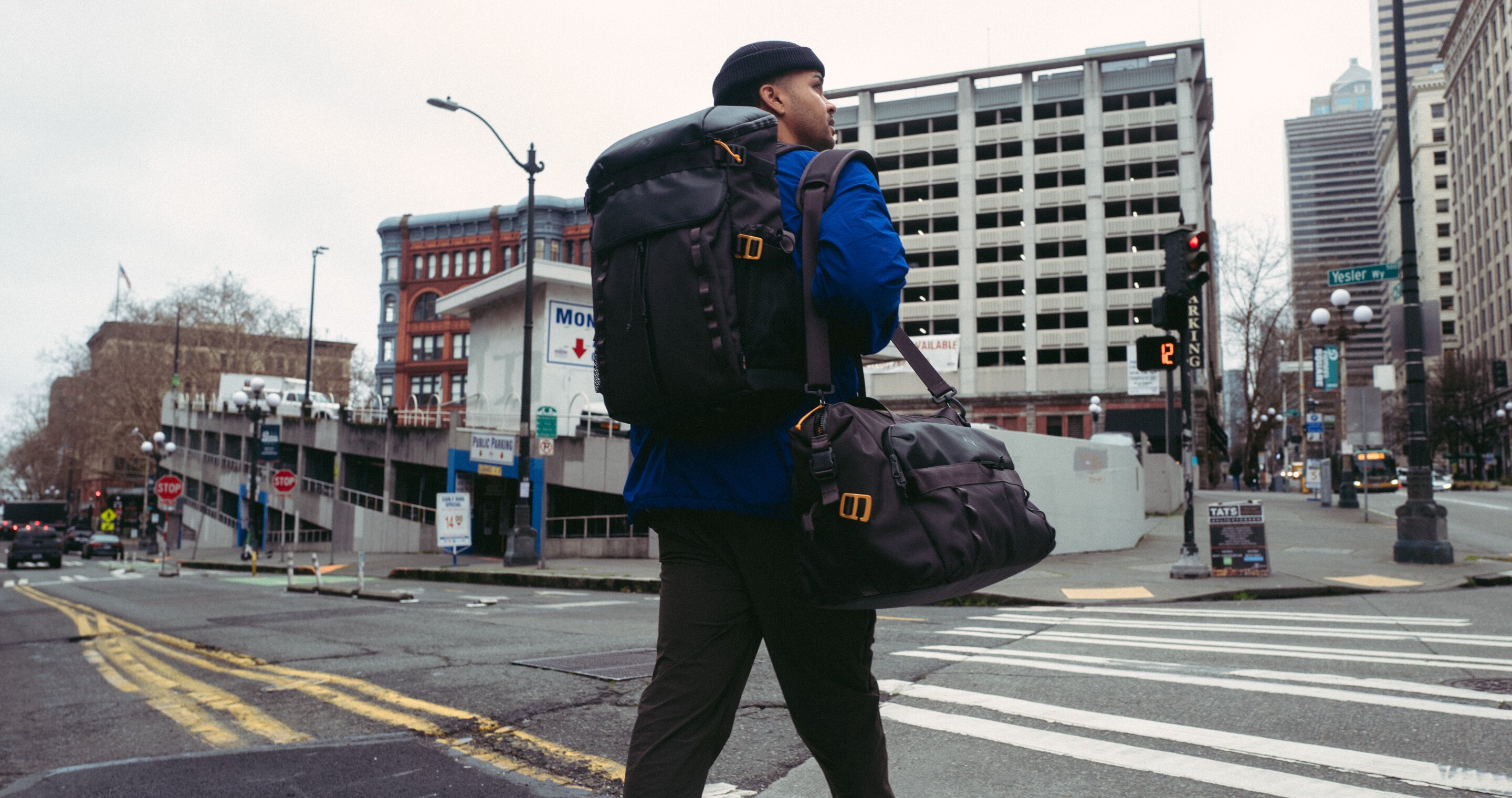 Man carrying bag through city.