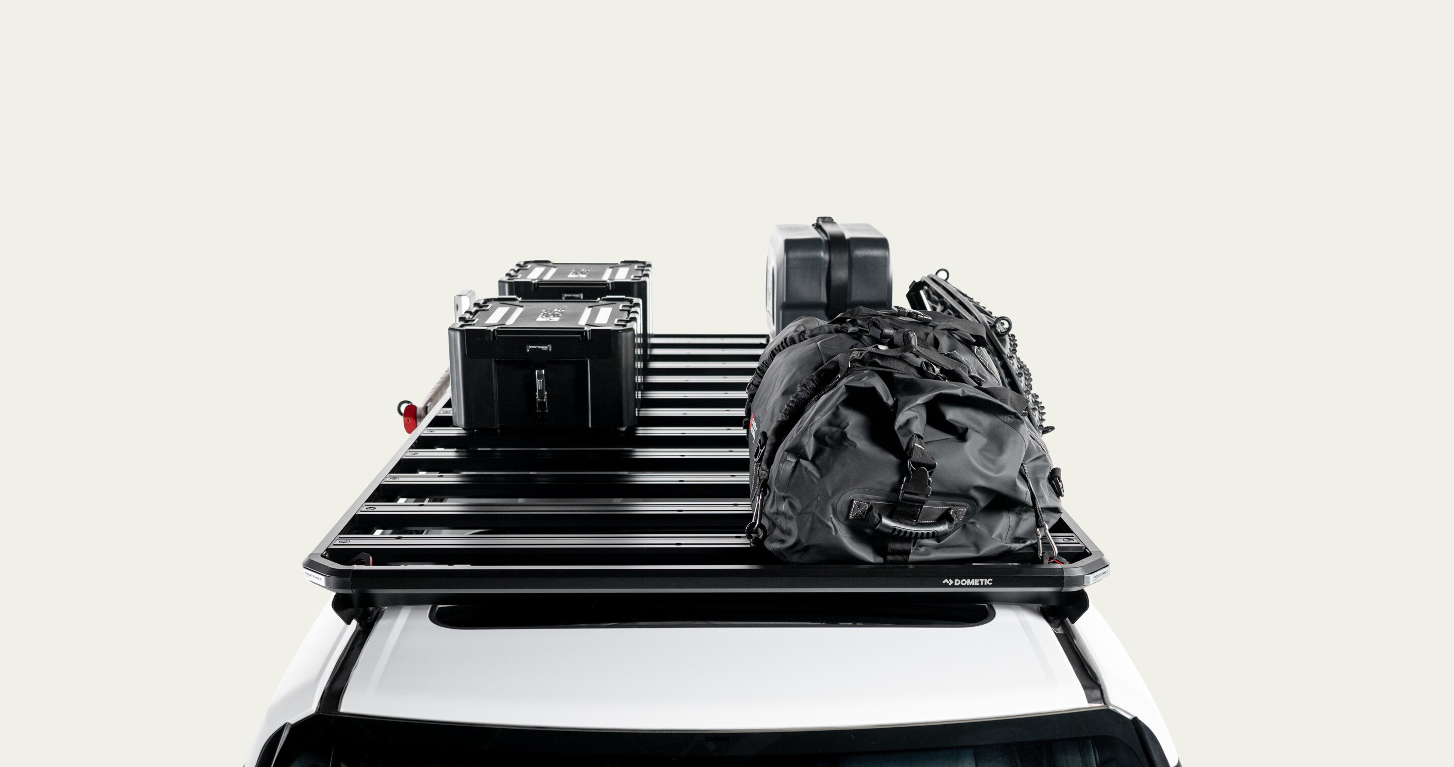 Slimline 3 roof rack loaded with storage boxes, jerry can and gear bag, modular roof rack platform shown mounted on a vehicle