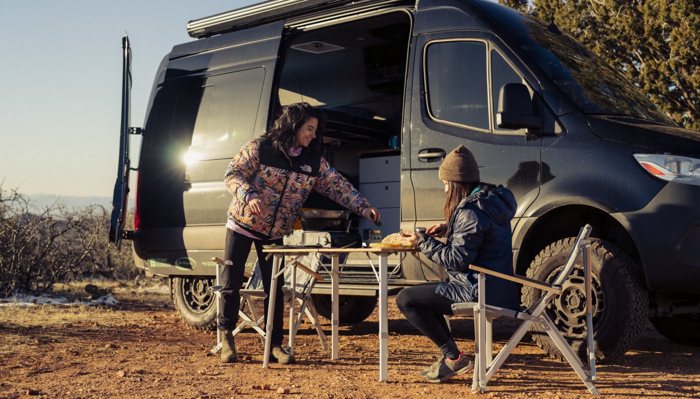 Nina William's and friend eating outside of van