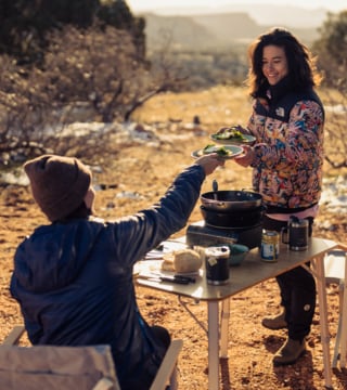 Women serving food while camping