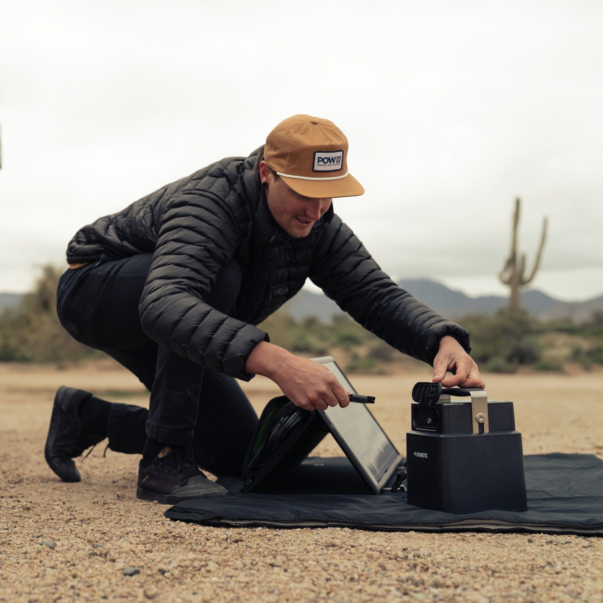 man hooking up solar off grid camping