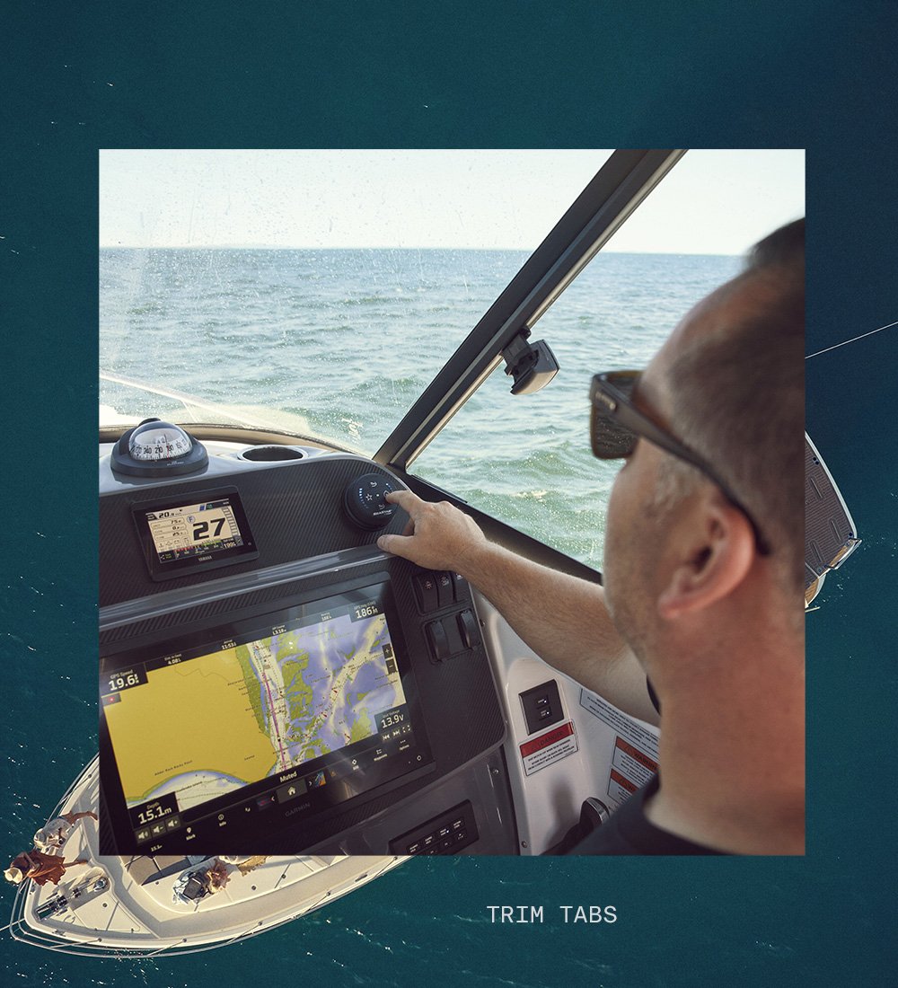 Person on boat with sunglasses adjusting trim tab dial