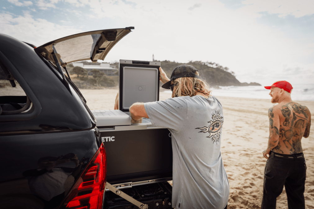 Image of male holding surfboard