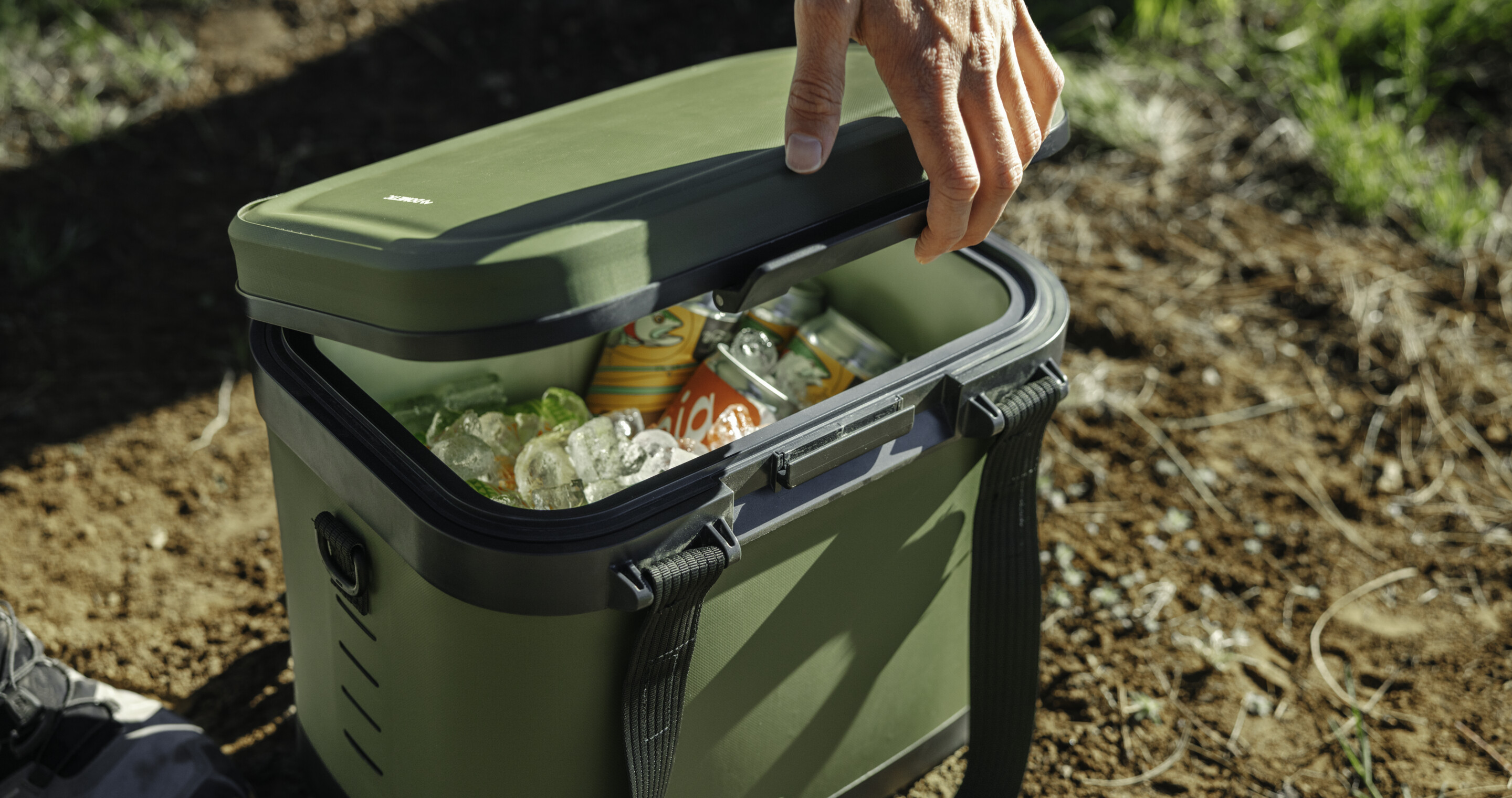 Opening soft cooler full of canned drinks.
