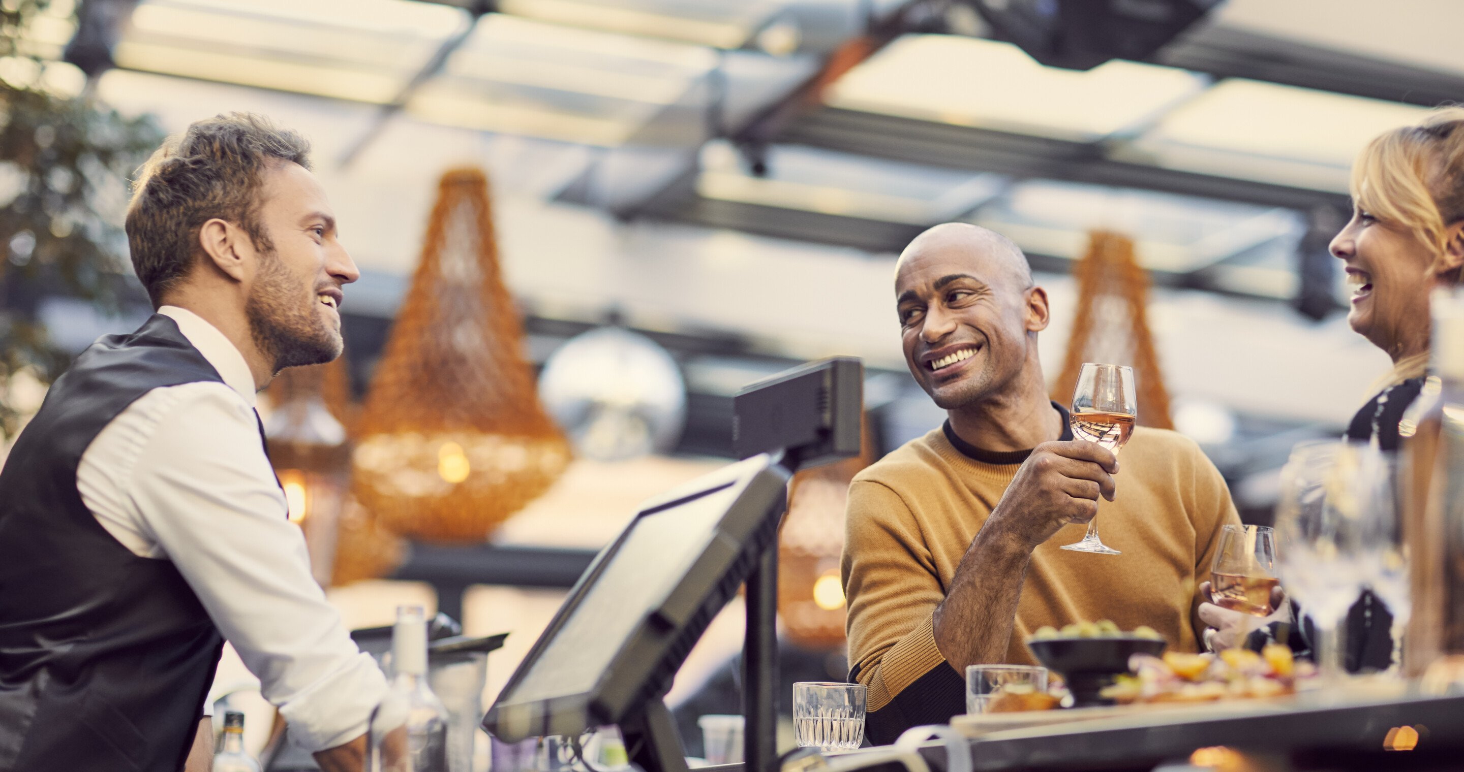 Guests talking with bartender