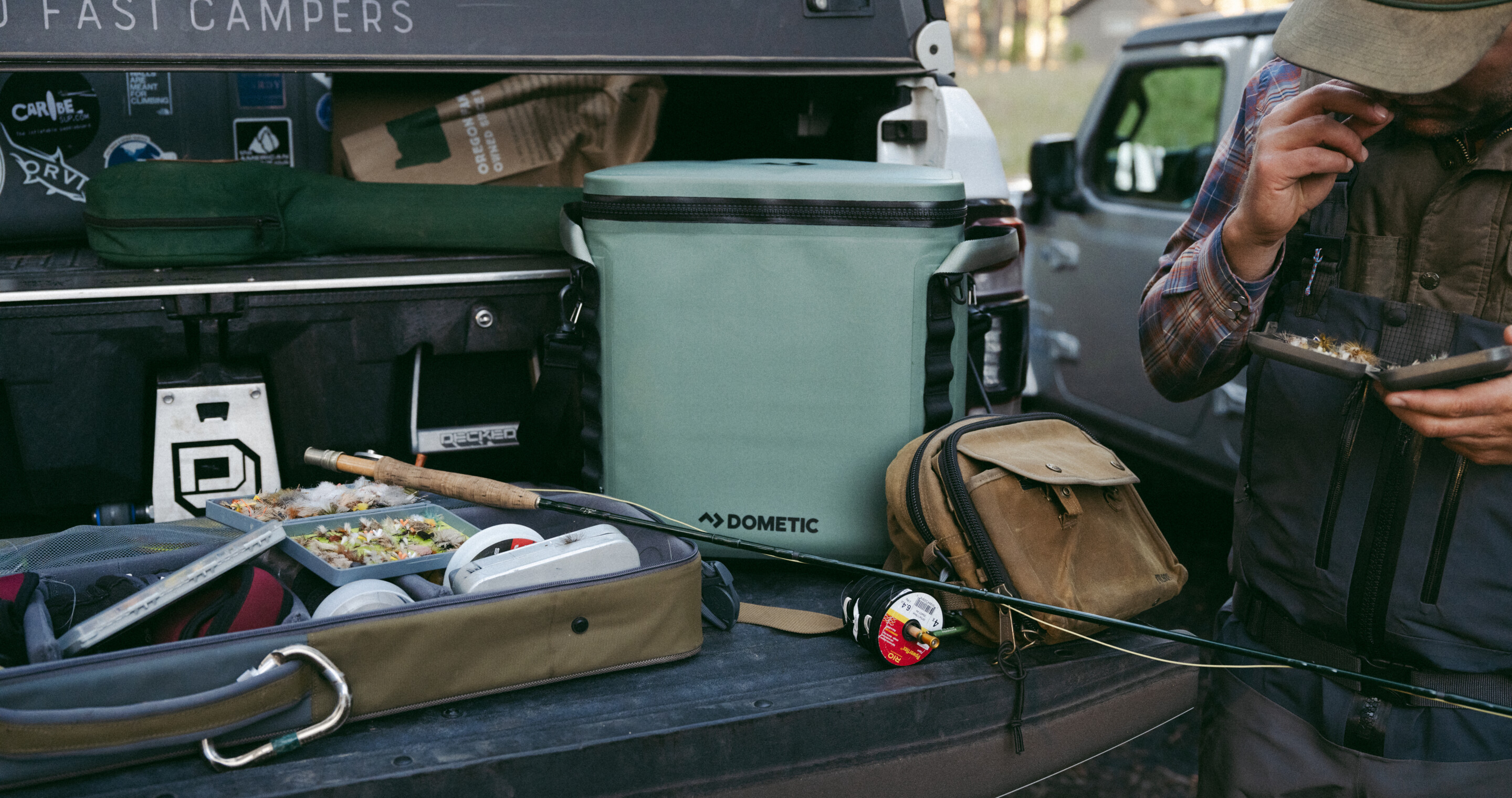 Soft cooler among fishing equipment on flatbed truck