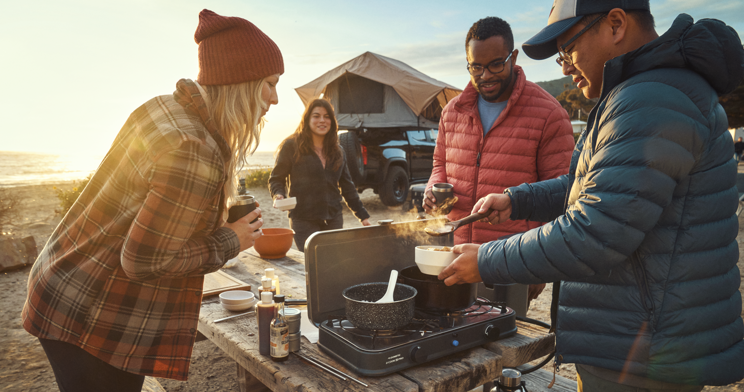 Family cooking outdoors with Dometic  Water Jug